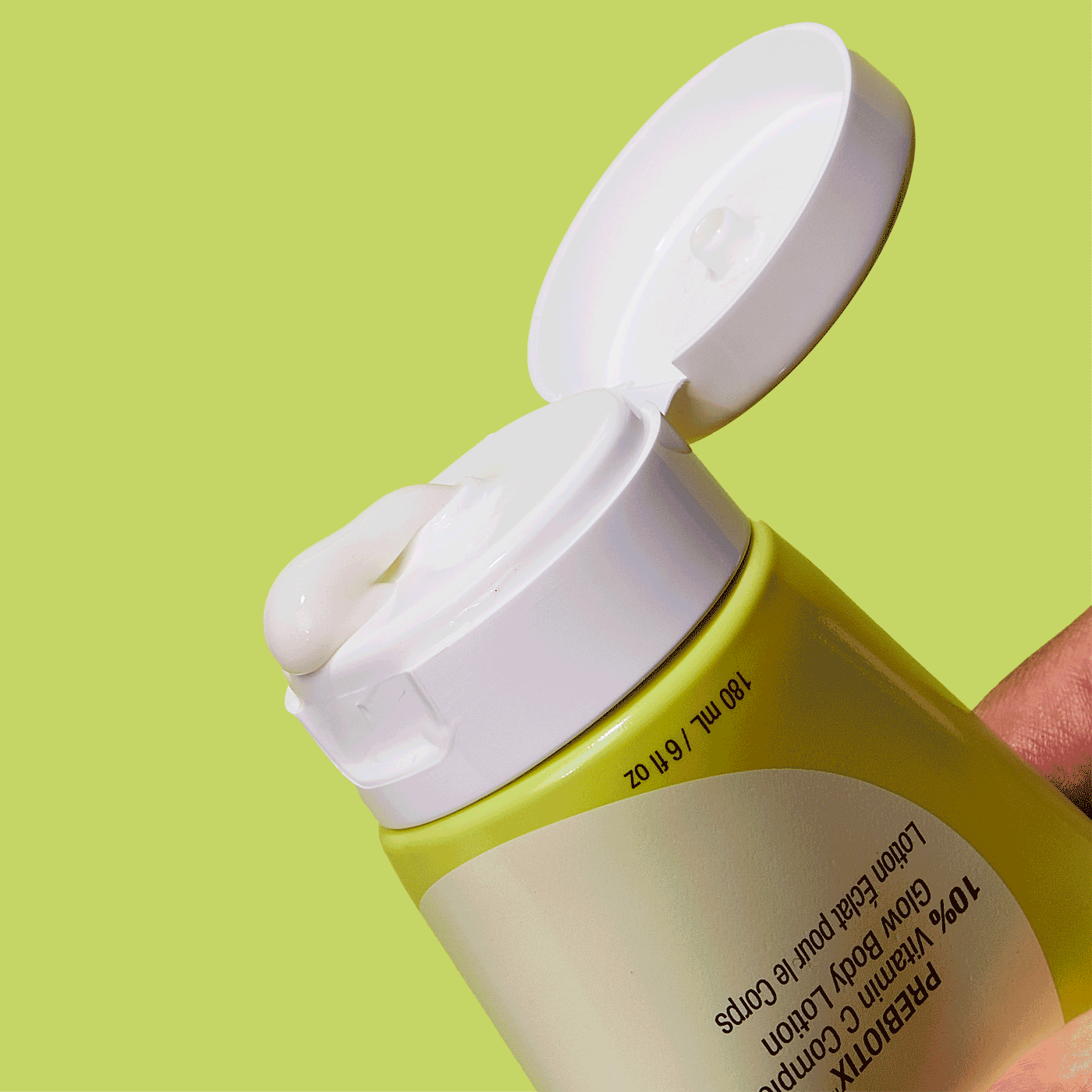 PREBIOTIX 10% Vitamin C Complex Glow Body Lotion Being Squeezed From Tube