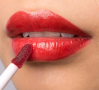 A Woman Putting on Red Lipstick