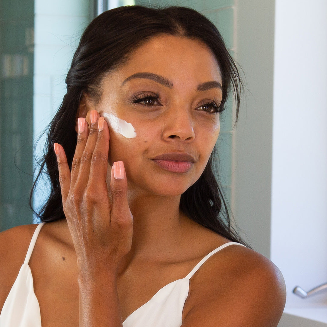 Woman using PREBIOTIC Cleansing Cream