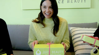 Woman Opening a Gift from Juice Beauty