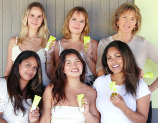 Women Wearing and Holding Juice Beauty Prebiotix SPF 45 